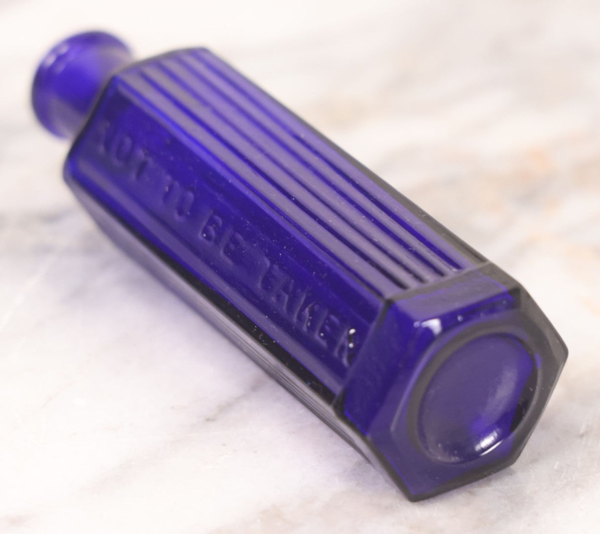 Lot 065 - Grouping Of Three Antique Cobalt Blue Glass Poison Bottles With Embossed Lettering “Not To Be Taken,” Hexagonal Form With Vertical Poison Ribs, Two 2Oz And One 3Oz, 3Oz Marked Y.C. Co.