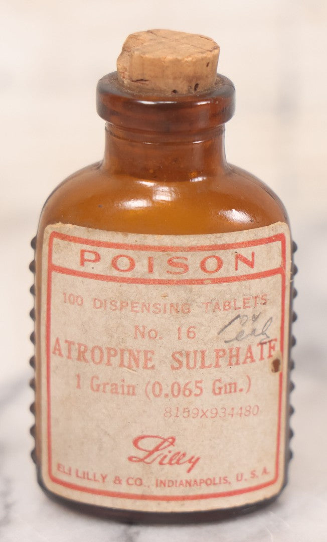 Lot 068 - Grouping Of Five Antique Amber Glass Poison Bottles With Horizontal Poison Ribs, Including Faded Eli Lilly & Co. Label And Kern Pharmacy Label, Flushing, New York, One With Eli Lilly & Co. Atropine Sulphate Label, And Three Without Labels