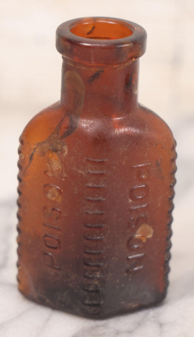 Lot 068 - Grouping Of Five Antique Amber Glass Poison Bottles With Horizontal Poison Ribs, Including Faded Eli Lilly & Co. Label And Kern Pharmacy Label, Flushing, New York, One With Eli Lilly & Co. Atropine Sulphate Label, And Three Without Labels