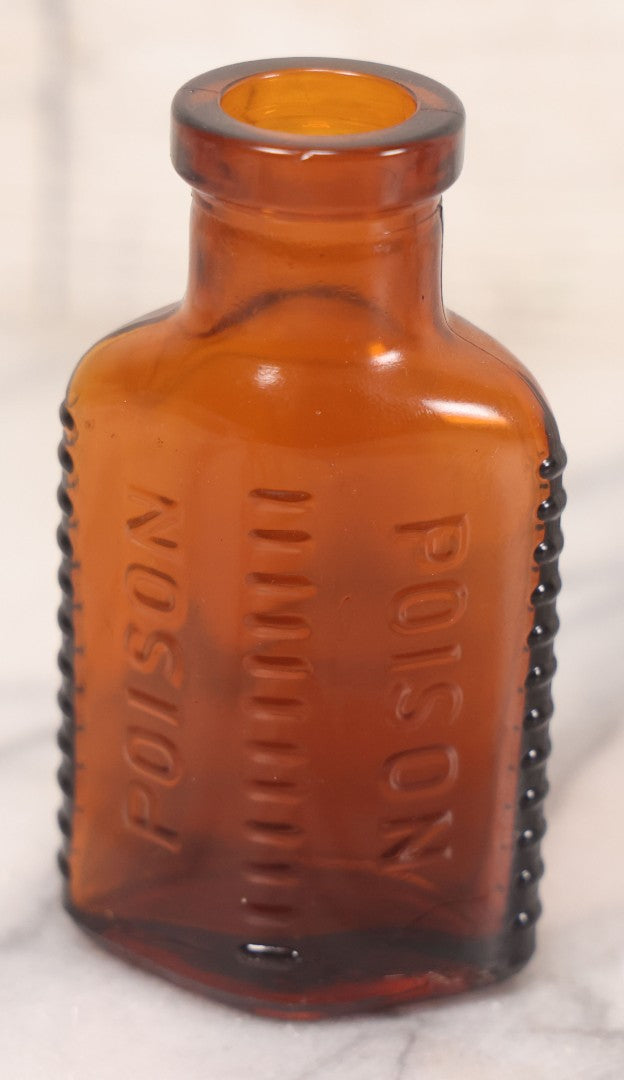 Lot 068 - Grouping Of Five Antique Amber Glass Poison Bottles With Horizontal Poison Ribs, Including Faded Eli Lilly & Co. Label And Kern Pharmacy Label, Flushing, New York, One With Eli Lilly & Co. Atropine Sulphate Label, And Three Without Labels
