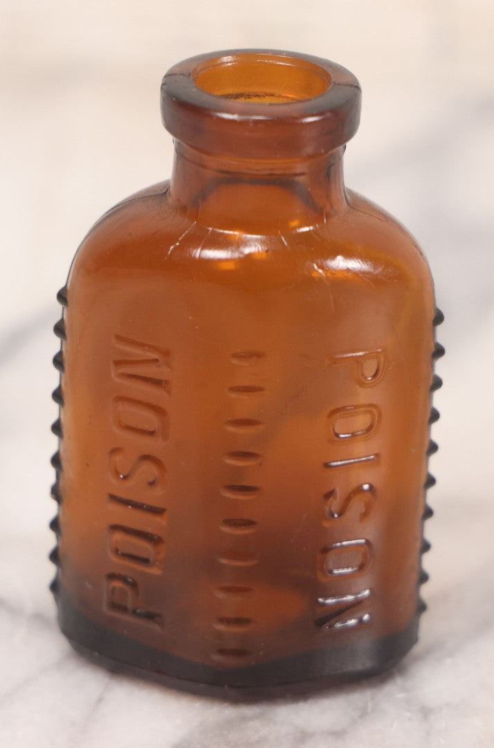 Lot 068 - Grouping Of Five Antique Amber Glass Poison Bottles With Horizontal Poison Ribs, Including Faded Eli Lilly & Co. Label And Kern Pharmacy Label, Flushing, New York, One With Eli Lilly & Co. Atropine Sulphate Label, And Three Without Labels