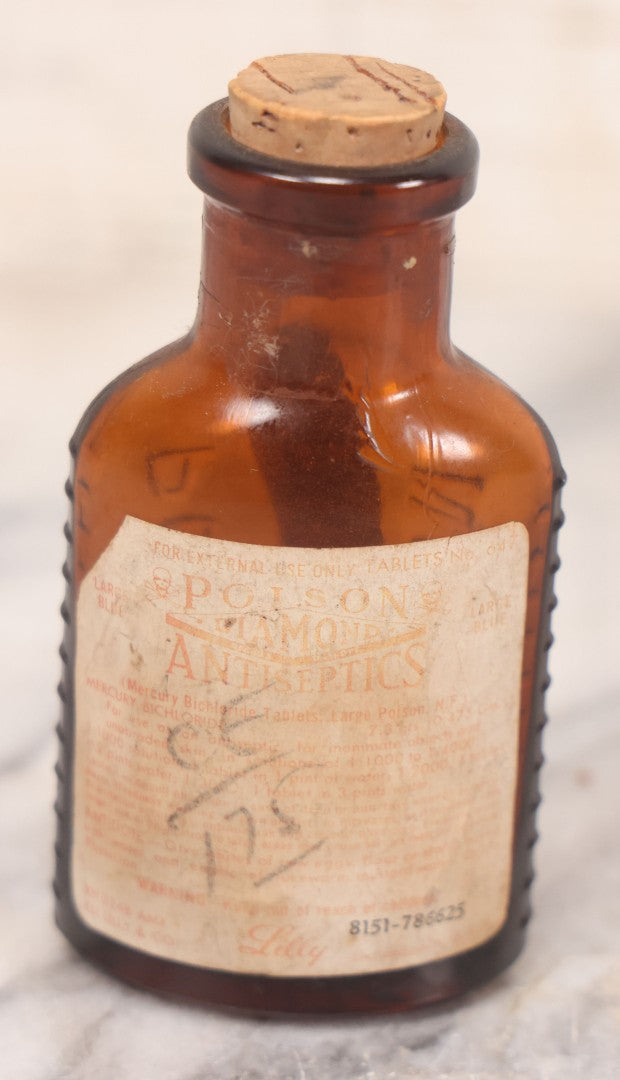 Lot 068 - Grouping Of Five Antique Amber Glass Poison Bottles With Horizontal Poison Ribs, Including Faded Eli Lilly & Co. Label And Kern Pharmacy Label, Flushing, New York, One With Eli Lilly & Co. Atropine Sulphate Label, And Three Without Labels