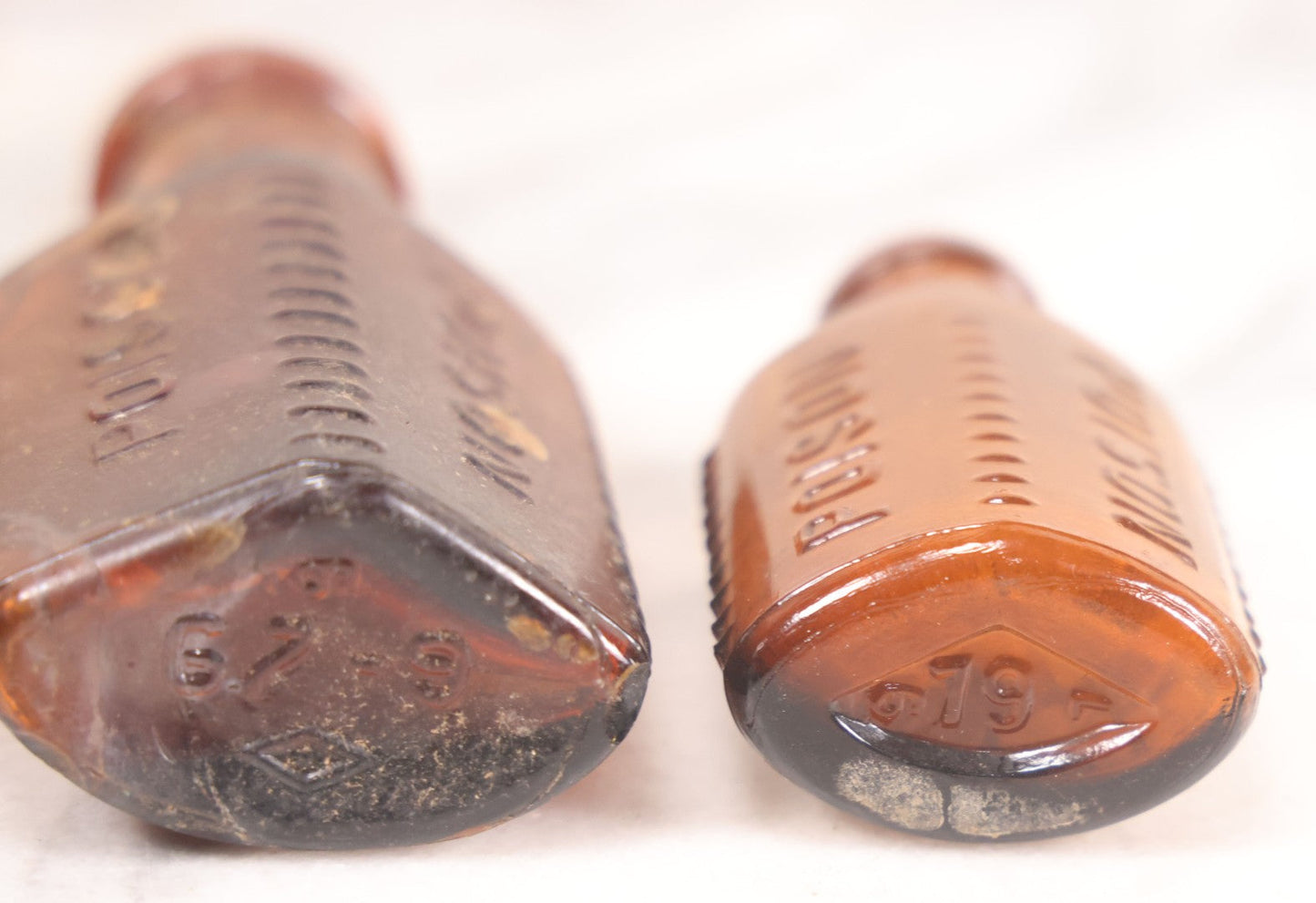 Lot 068 - Grouping Of Five Antique Amber Glass Poison Bottles With Horizontal Poison Ribs, Including Faded Eli Lilly & Co. Label And Kern Pharmacy Label, Flushing, New York, One With Eli Lilly & Co. Atropine Sulphate Label, And Three Without Labels