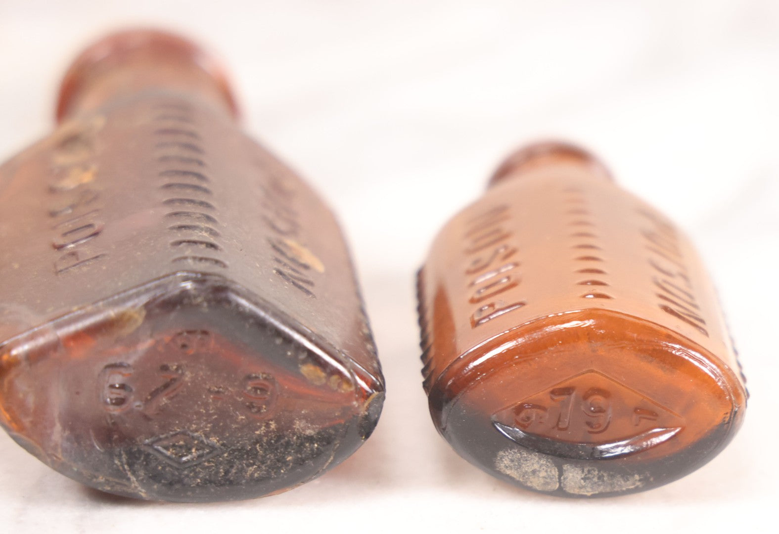 Lot 068 - Grouping Of Five Antique Amber Glass Poison Bottles With Horizontal Poison Ribs, Including Faded Eli Lilly & Co. Label And Kern Pharmacy Label, Flushing, New York, One With Eli Lilly & Co. Atropine Sulphate Label, And Three Without Labels
