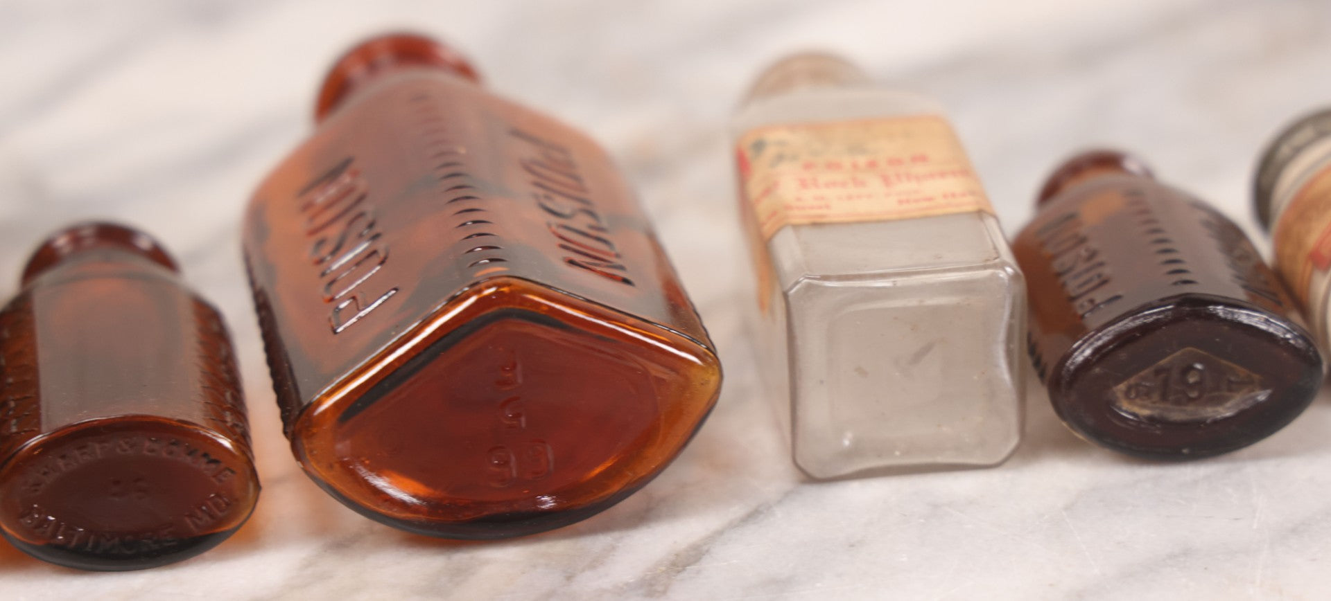 Lot 069 - Grouping Of Six Antique Poison Bottles Including Amber With Crosshatch Poison Ribs, Eli Lilly & Co. Diamond Antiseptics, Clear Chinum Arsenate With Eimer & Amend Lid, East Rock Pharmacy New Haven, And Liggett's Springfield, Ma