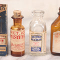 Lot 070 - Grouping Of Four Vintage Tincture Of Iodine Poison Bottles Including Saxon Brand In Partial Box, Rexall, Certified Pharmacal Co. Inc. New York, And Opperman's Drug Store, Torrington, Connecticut