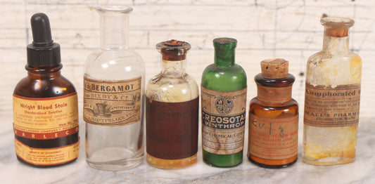 Lot 071 - Grouping Of Six Antique And Vintage Bottles Including Camphorated Oil From Small's Pharmacy, Stonington, Maine, Oil Of Bergamot From Bixby & Co., Montpelier, Vermont, Wright Blood Stain From Hartman Leddon Co., Philadelphia, And Others
