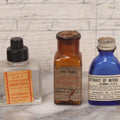 Lot 073 - Grouping Of Five Antique Bottles With Paper Labels Including Witch Hazel, John Laws, Columbus M.S., Spirit Of Peppermint, Koch's Pharm., Greenwich, R.I., Potassium Metabisulphate, Kodak, Mercury, Guterman Dental, N.Y., & Nux Vomica