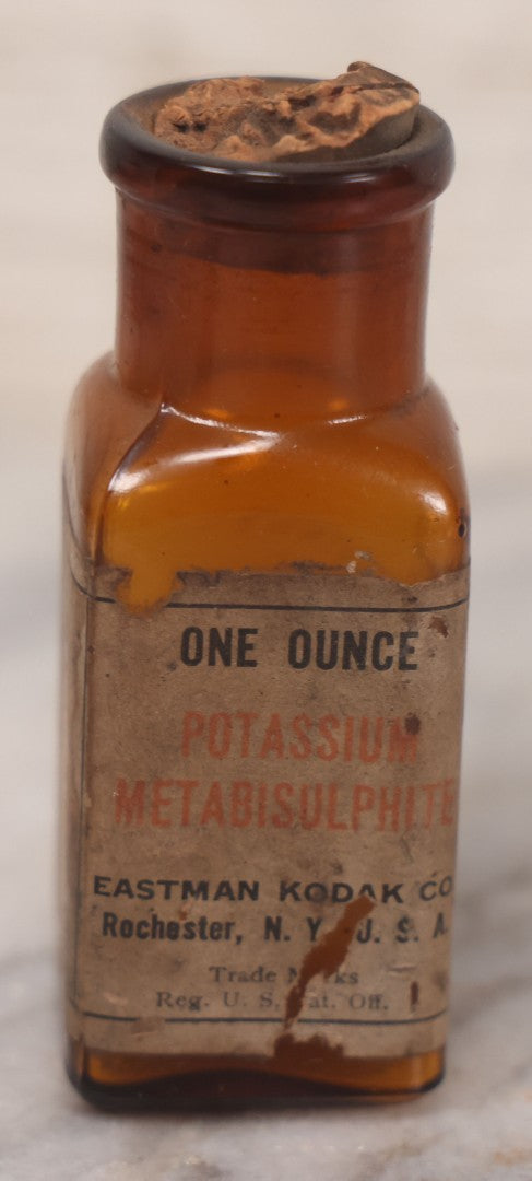 Lot 073 - Grouping Of Five Antique Bottles With Paper Labels Including Witch Hazel, John Laws, Columbus M.S., Spirit Of Peppermint, Koch's Pharm., Greenwich, R.I., Potassium Metabisulphate, Kodak, Mercury, Guterman Dental, N.Y., & Nux Vomica