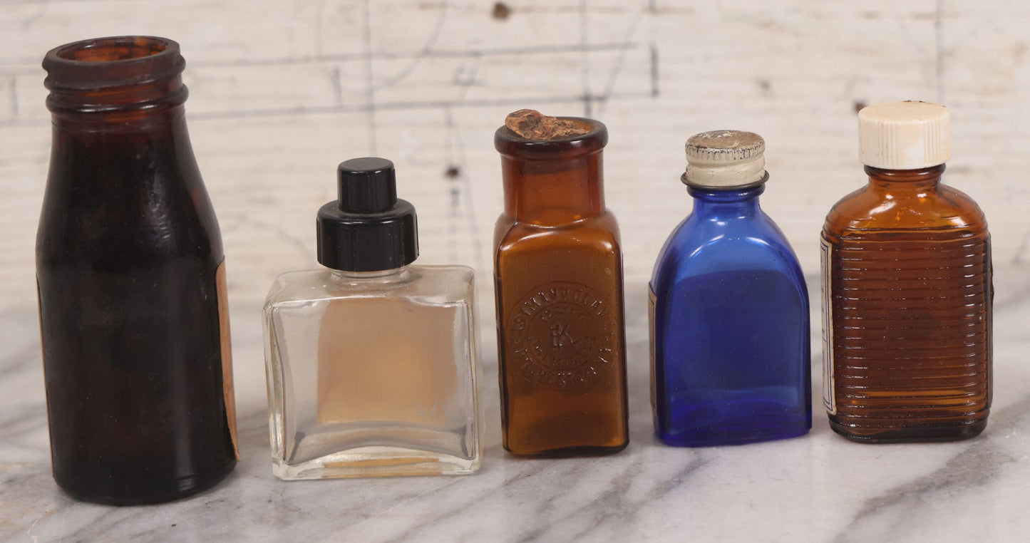 Lot 073 - Grouping Of Five Antique Bottles With Paper Labels Including Witch Hazel, John Laws, Columbus M.S., Spirit Of Peppermint, Koch's Pharm., Greenwich, R.I., Potassium Metabisulphate, Kodak, Mercury, Guterman Dental, N.Y., & Nux Vomica