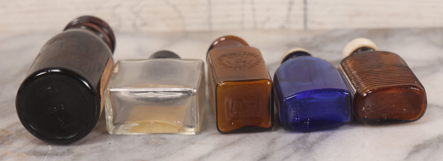 Lot 073 - Grouping Of Five Antique Bottles With Paper Labels Including Witch Hazel, John Laws, Columbus M.S., Spirit Of Peppermint, Koch's Pharm., Greenwich, R.I., Potassium Metabisulphate, Kodak, Mercury, Guterman Dental, N.Y., & Nux Vomica