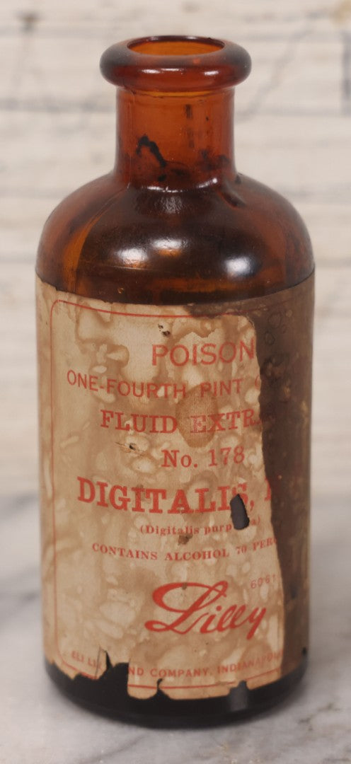 Lot 074 - Grouping Of Five Antique Amber Glass Bottles Including Digitalis From Eli Lilly & Co., Indianapolis, Phytolacca From Parke, Davis & Co., Detroit, De Mercure Codex 1908, And Kola From Eli Lilly & Co., And Others