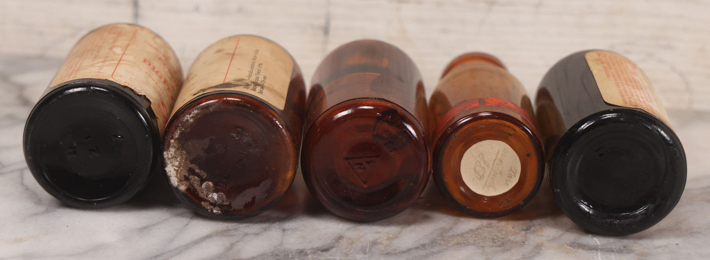 Lot 074 - Grouping Of Five Antique Amber Glass Bottles Including Digitalis From Eli Lilly & Co., Indianapolis, Phytolacca From Parke, Davis & Co., Detroit, De Mercure Codex 1908, And Kola From Eli Lilly & Co., And Others