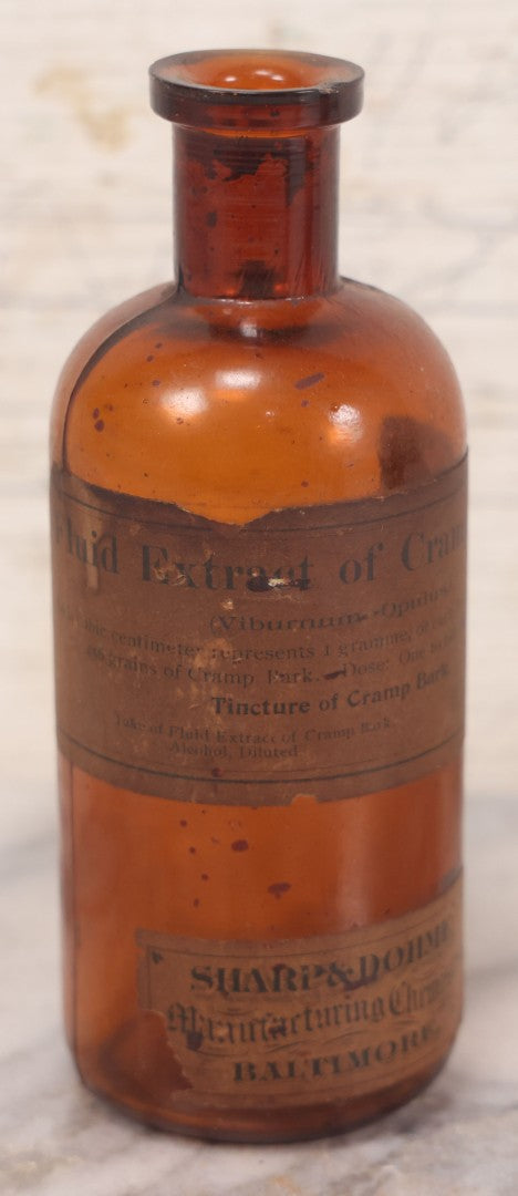 Lot 075 - Grouping Of Four Antique Amber Glass Bottles Including Cramp Bark From Sharp & Dohme, Baltimore, Sanguinaria From John Wyeth & Brother, Philadelphia, H.K. Mulford Co., Philadelphia, And One Unmarked With Stopper