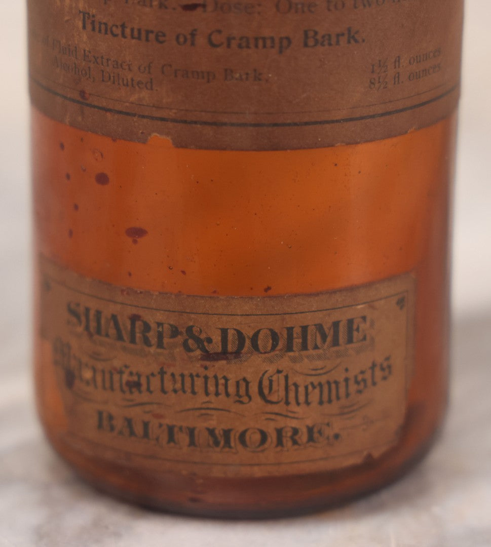 Lot 075 - Grouping Of Four Antique Amber Glass Bottles Including Cramp Bark From Sharp & Dohme, Baltimore, Sanguinaria From John Wyeth & Brother, Philadelphia, H.K. Mulford Co., Philadelphia, And One Unmarked With Stopper