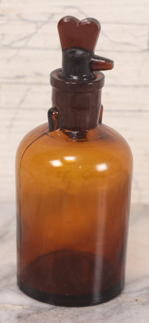 Lot 075 - Grouping Of Four Antique Amber Glass Bottles Including Cramp Bark From Sharp & Dohme, Baltimore, Sanguinaria From John Wyeth & Brother, Philadelphia, H.K. Mulford Co., Philadelphia, And One Unmarked With Stopper