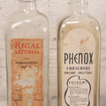 Lot 077 - Pair Of Vintage Clear Glass Embalming Fluid Bottles With Paper Labels And Caps Including Regal Arterial From Regal Fluid Co., Washington, D.C., And Hydrol Phenox From Hydrol Chemical Co., Philadelphia