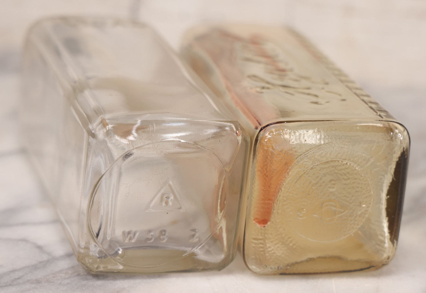 Lot 077 - Pair Of Vintage Clear Glass Embalming Fluid Bottles With Paper Labels And Caps Including Regal Arterial From Regal Fluid Co., Washington, D.C., And Hydrol Phenox From Hydrol Chemical Co., Philadelphia