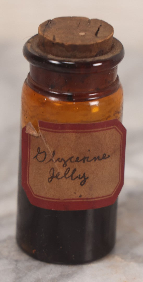 Lot 078 - Grouping Of Eight Antique Apothecary Items Including Amber Bottle With "G.C. Oval" Label, Balsam Bottle, Hall & Lyon Co. Pill Box, Carter's Laxative Vial, Wheeler Pharmacist Vial, Sharon, M.A., Glycerine Jelly Bottle, & John Bull Eye Wash Cup