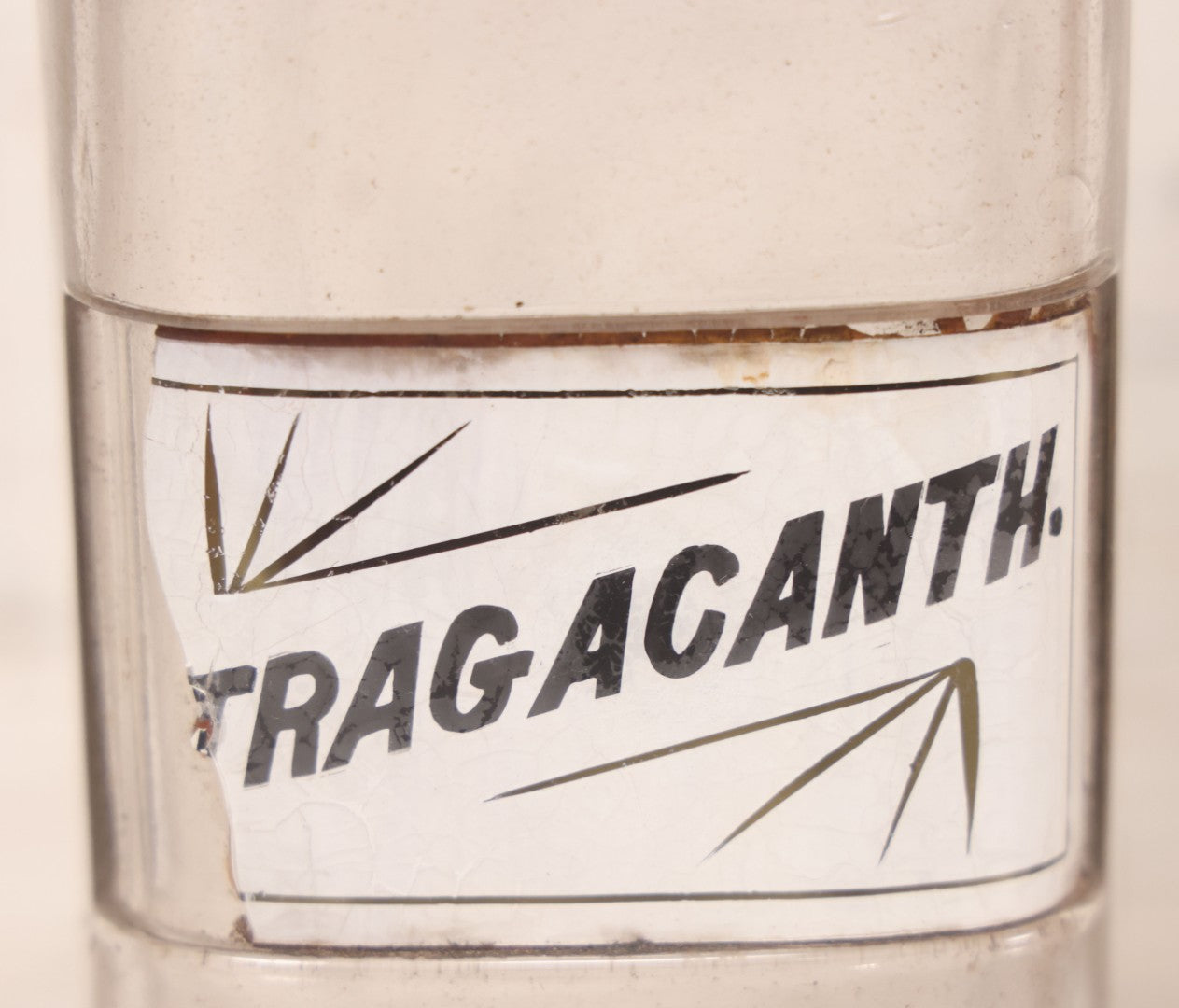 Lot 080 - Grouping Of Three Antique Whitall Tatum Co. Clear Glass Apothecary Bottles With Stoppers And Partial Reverse Painted Labels Including Syr. Sarsap. Co., Saponis, And Tragacanth