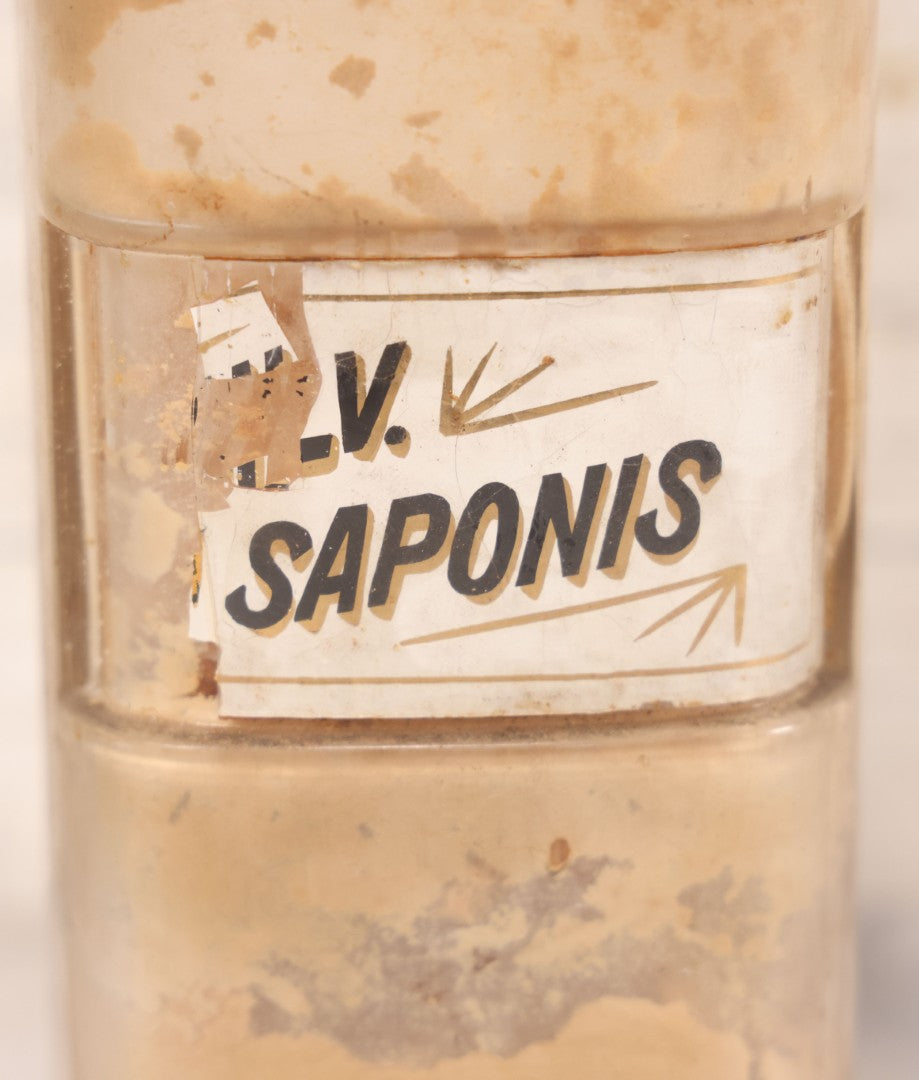 Lot 080 - Grouping Of Three Antique Whitall Tatum Co. Clear Glass Apothecary Bottles With Stoppers And Partial Reverse Painted Labels Including Syr. Sarsap. Co., Saponis, And Tragacanth