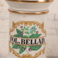 Lot 083 - Reproduction Fantasy Apothecary Jar With Lid Marked “Fol. Bellad.” White Opaque Pottery With Gold Painted Lines, Mid-20th Century, Bottom Marked Made In U.S.A., 7-5/8" H