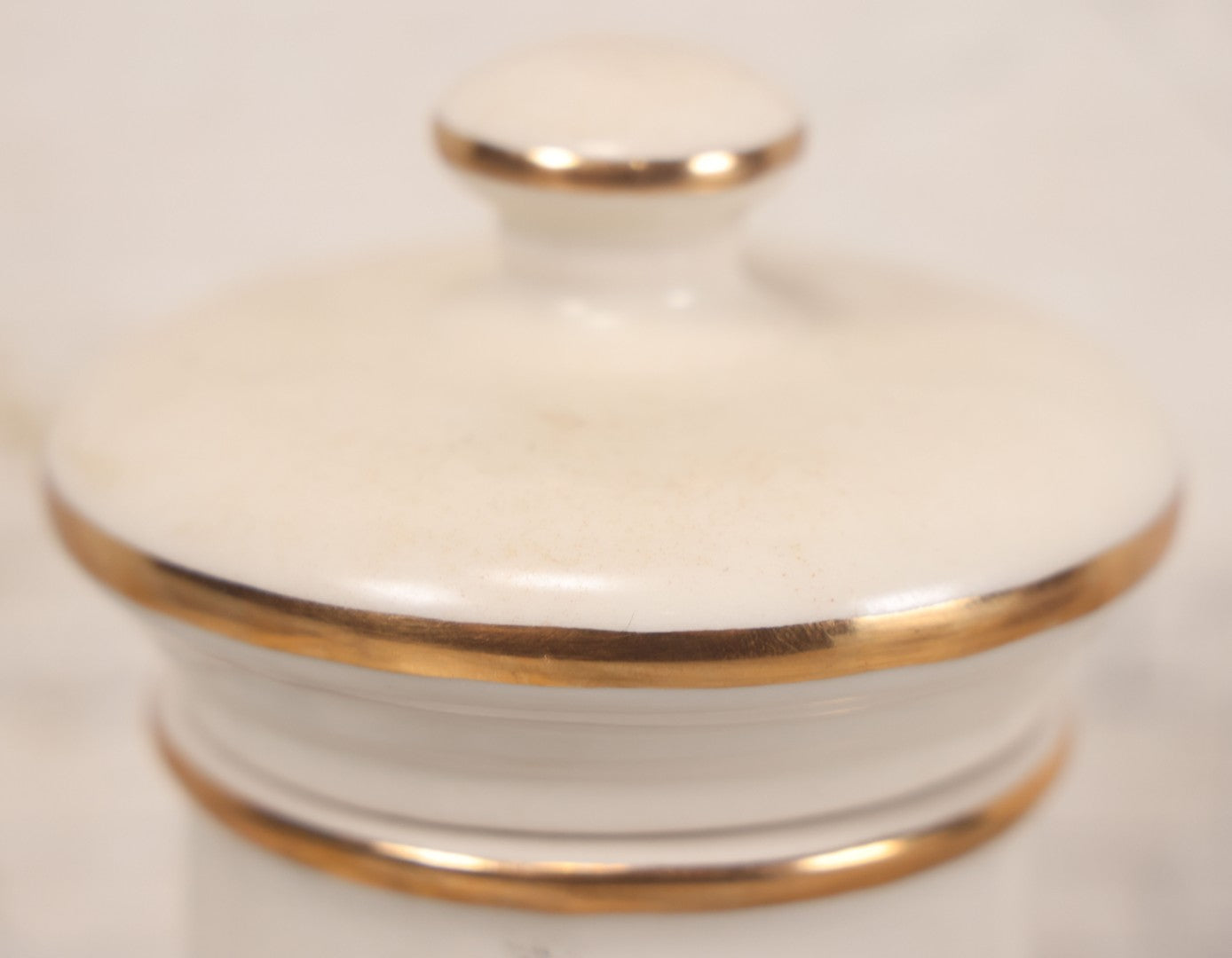 Lot 083 - Reproduction Fantasy Apothecary Jar With Lid Marked “Fol. Bellad.” White Opaque Pottery With Gold Painted Lines, Mid-20th Century, Bottom Marked Made In U.S.A., 7-5/8" H