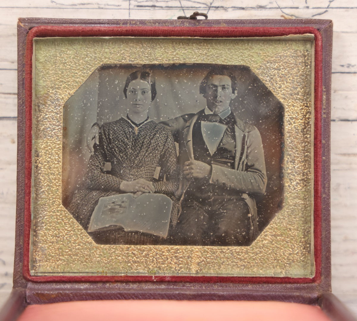 Lot 093 - Antique 1/6th Plate Daguerreotype Photograph Of Couple In Full Leatherette Case, Gold Painted Border, Faded Red Cushion, Anthony, Clark & Co. Label On Verso, Note Damage To Case