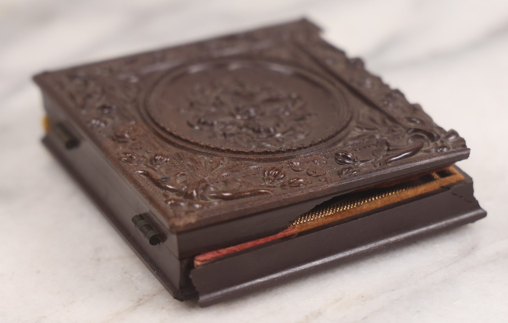 Lot 094 - Antique 1/6th Plate Daguerreotype Photograph Of Man In Full Thermoplastic Case With Abstract Floral Design, Brass Mat, Dark Red Cushion, Heavily Speckled Surface Of Photograph, Note Damage To Case