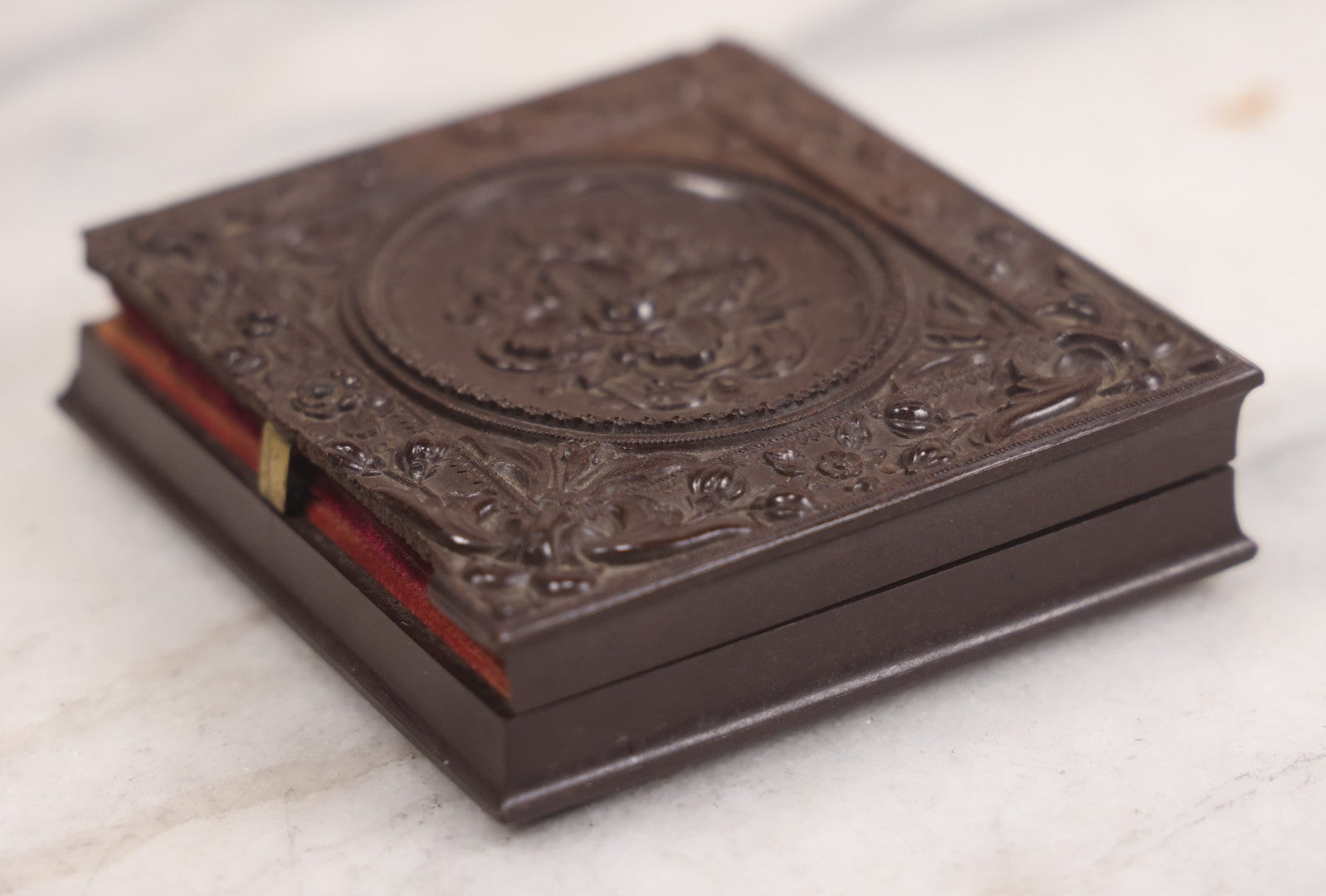 Lot 094 - Antique 1/6th Plate Daguerreotype Photograph Of Man In Full Thermoplastic Case With Abstract Floral Design, Brass Mat, Dark Red Cushion, Heavily Speckled Surface Of Photograph, Note Damage To Case