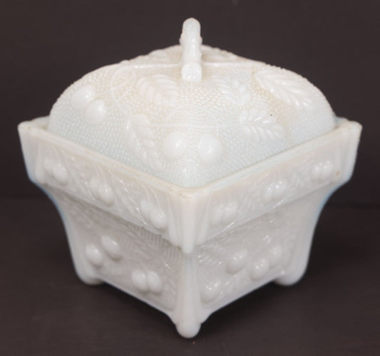 Lot 135 - Antique Milk Glass Covered Dish With Embossed Fruit And Leaf Design On Four Feet, Note Chipped Corner