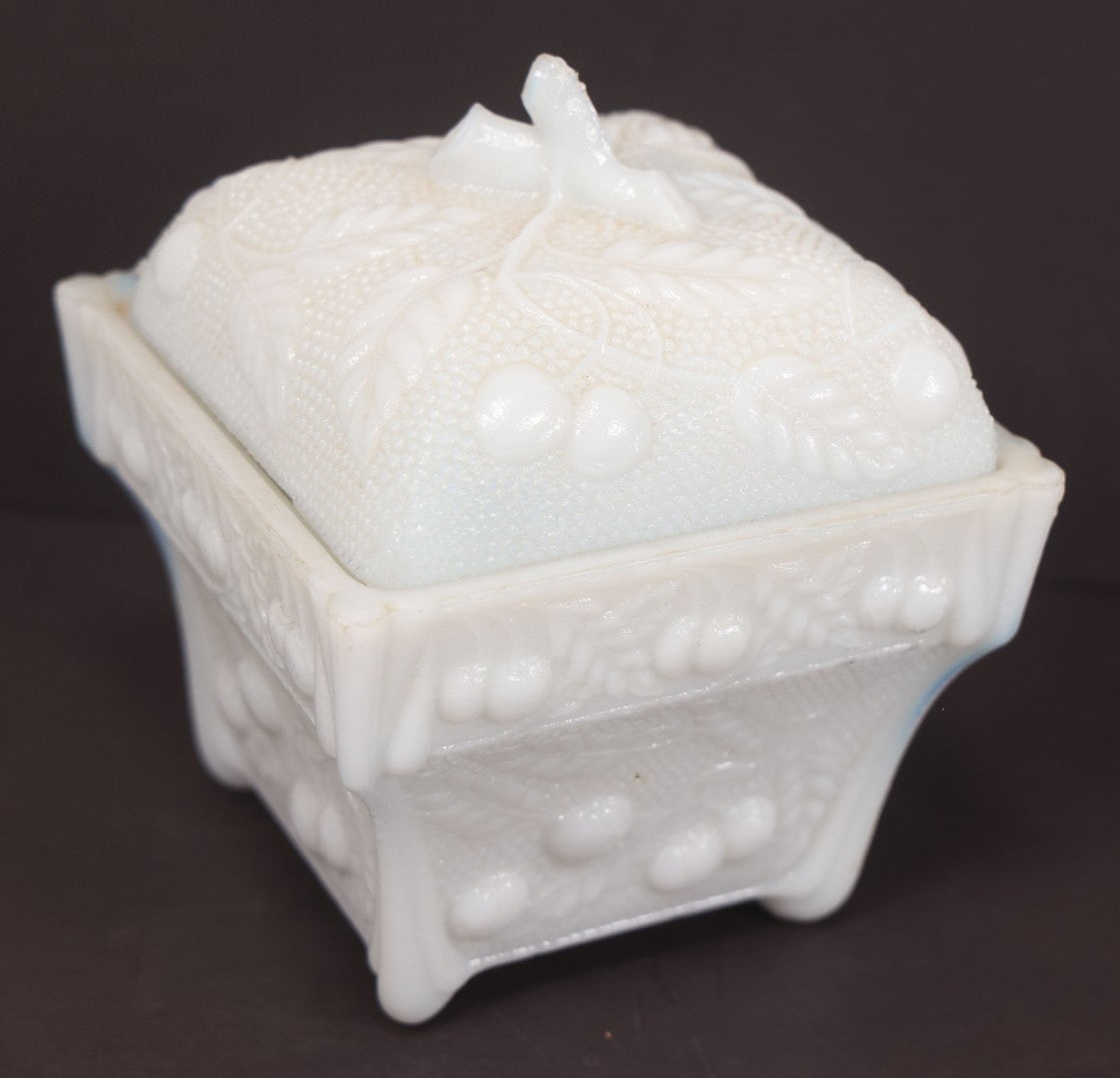 Lot 135 - Antique Milk Glass Covered Dish With Embossed Fruit And Leaf Design On Four Feet, Note Chipped Corner