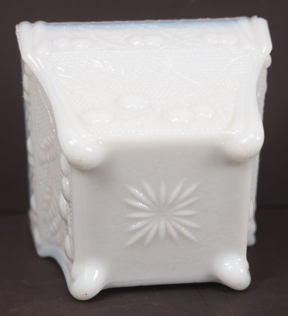 Lot 135 - Antique Milk Glass Covered Dish With Embossed Fruit And Leaf Design On Four Feet, Note Chipped Corner