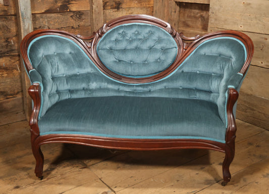 Antique Victorian Carved Walnut Settee With Tufted Blue Upholstery And Casters