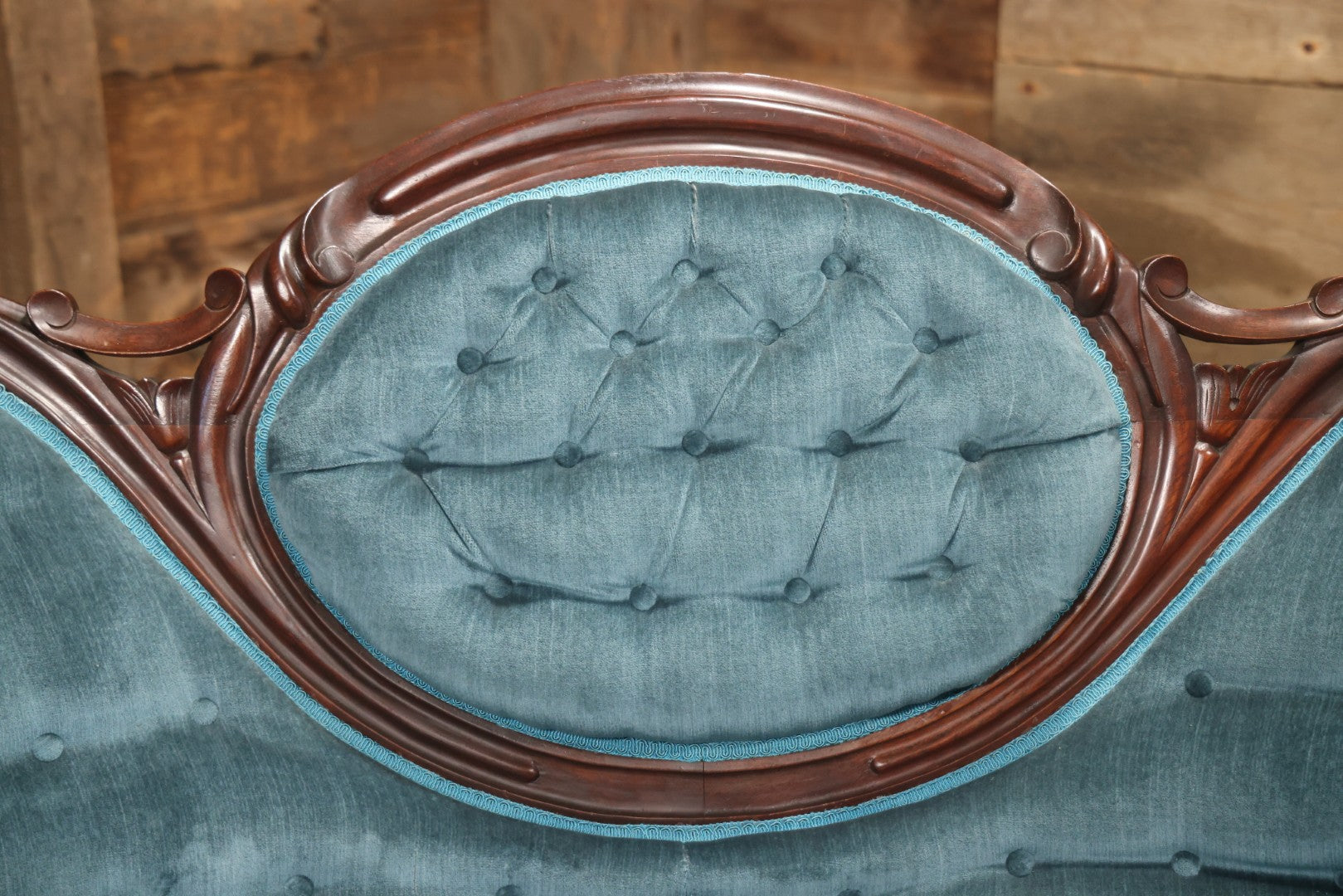 Antique Victorian Carved Walnut Settee With Tufted Blue Upholstery And Casters