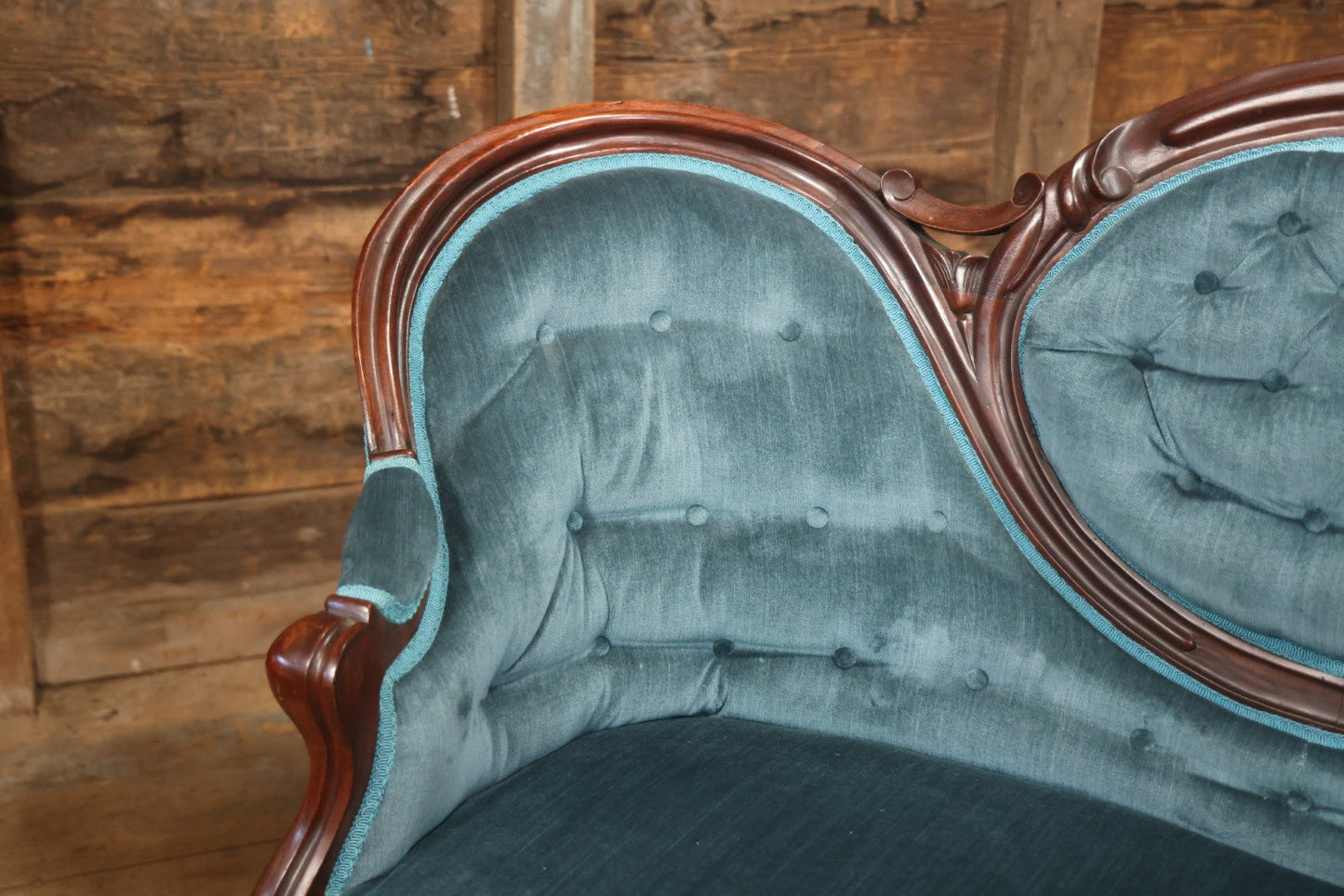 Antique Victorian Carved Walnut Settee With Tufted Blue Upholstery And Casters