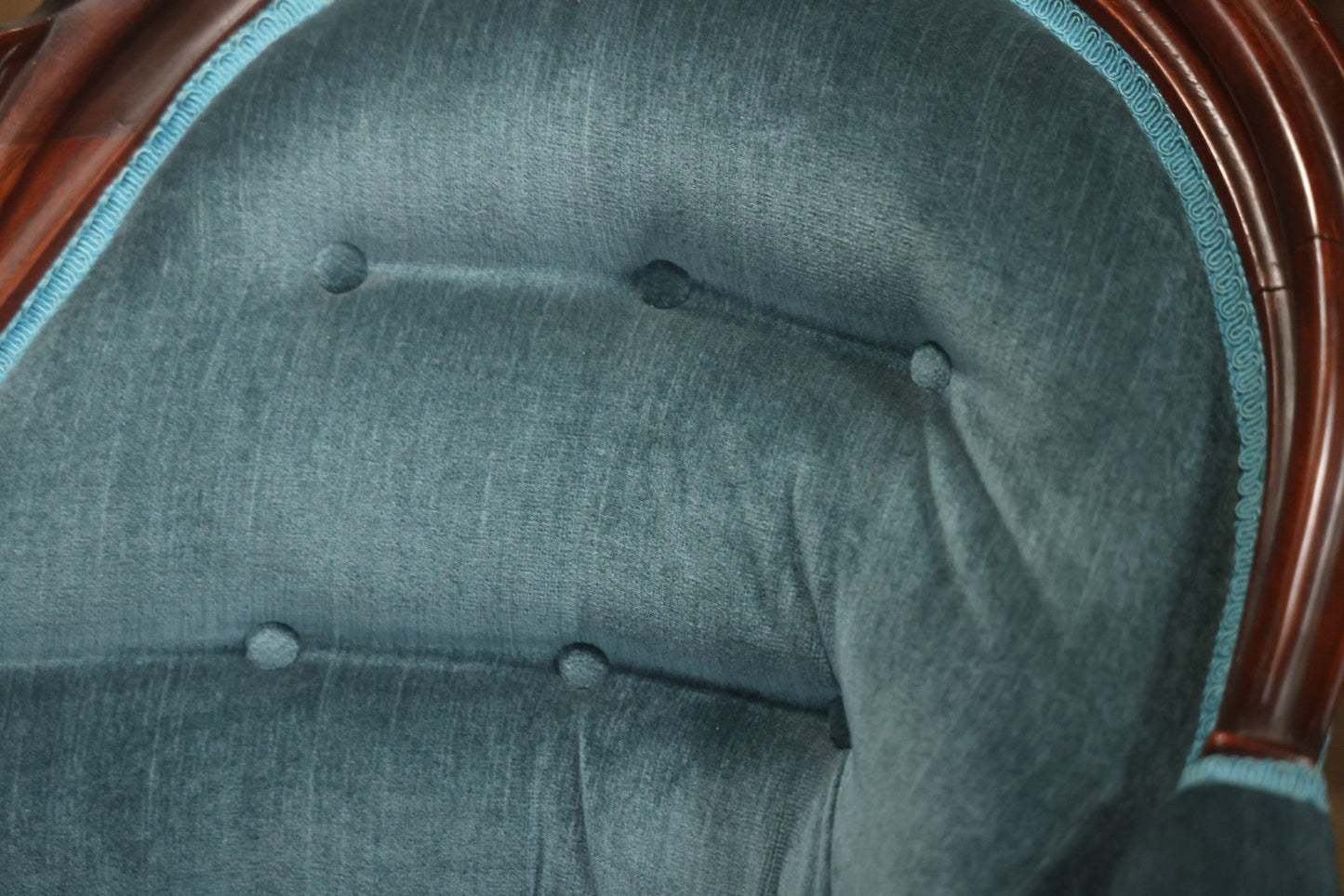 Antique Victorian Carved Walnut Settee With Tufted Blue Upholstery And Casters