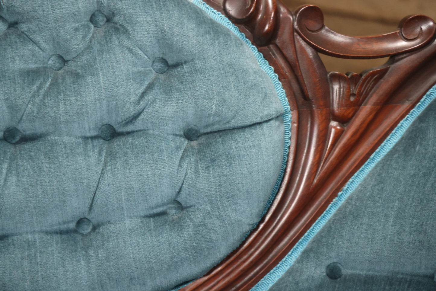 Antique Victorian Carved Walnut Settee With Tufted Blue Upholstery And Casters