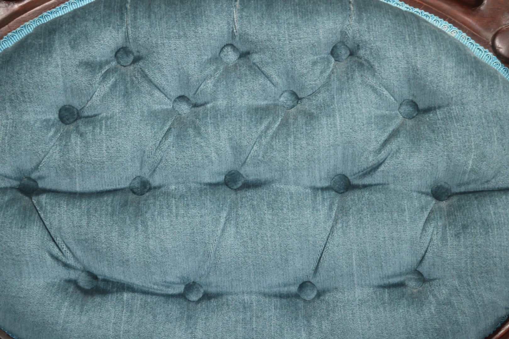 Antique Victorian Carved Walnut Settee With Tufted Blue Upholstery And Casters