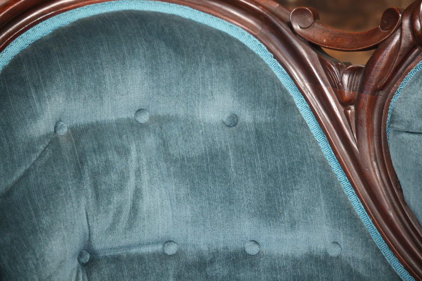 Antique Victorian Carved Walnut Settee With Tufted Blue Upholstery And Casters
