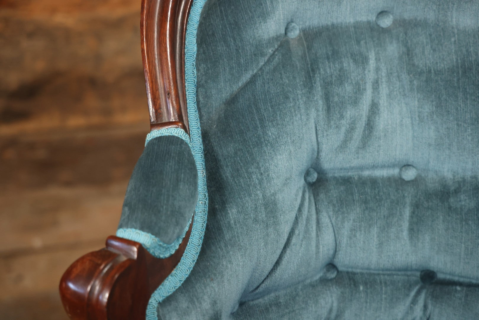 Antique Victorian Carved Walnut Settee With Tufted Blue Upholstery And Casters