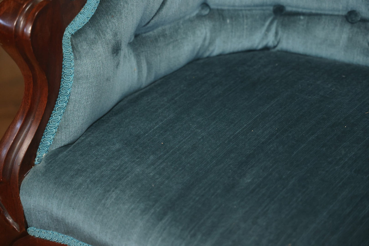 Antique Victorian Carved Walnut Settee With Tufted Blue Upholstery And Casters