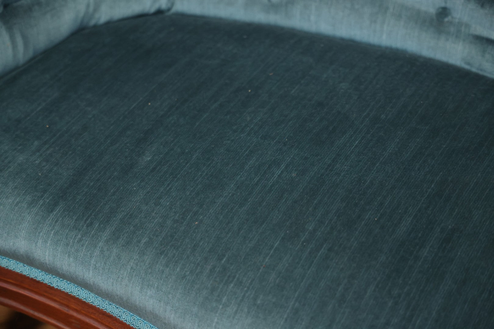 Antique Victorian Carved Walnut Settee With Tufted Blue Upholstery And Casters