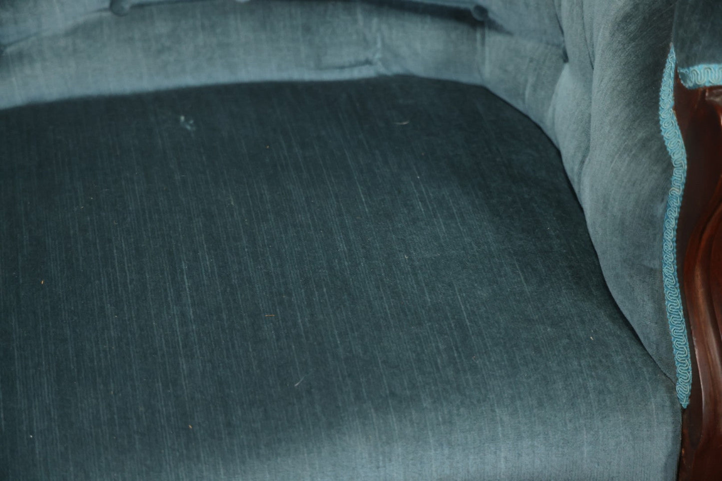 Antique Victorian Carved Walnut Settee With Tufted Blue Upholstery And Casters