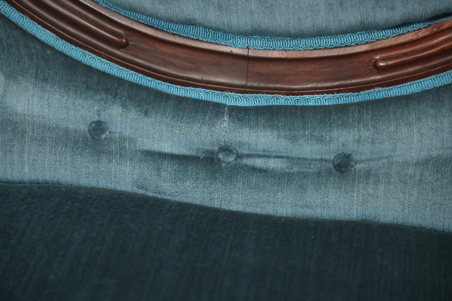 Antique Victorian Carved Walnut Settee With Tufted Blue Upholstery And Casters