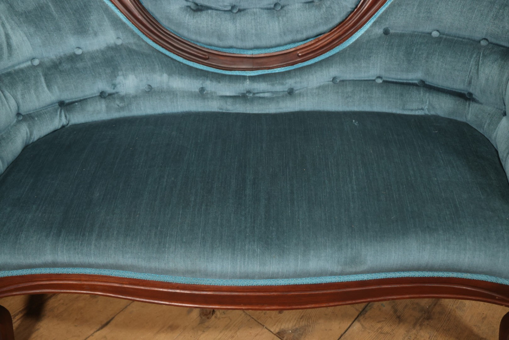 Antique Victorian Carved Walnut Settee With Tufted Blue Upholstery And Casters