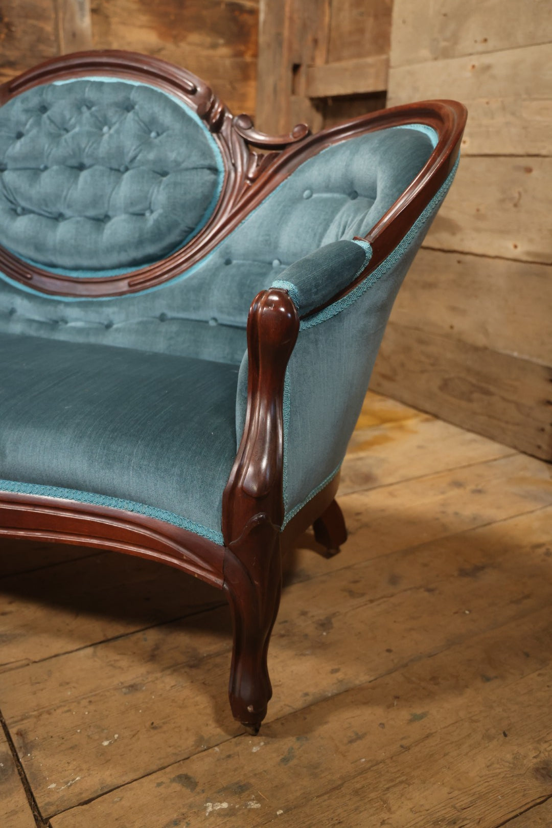 Antique Victorian Carved Walnut Settee With Tufted Blue Upholstery And Casters