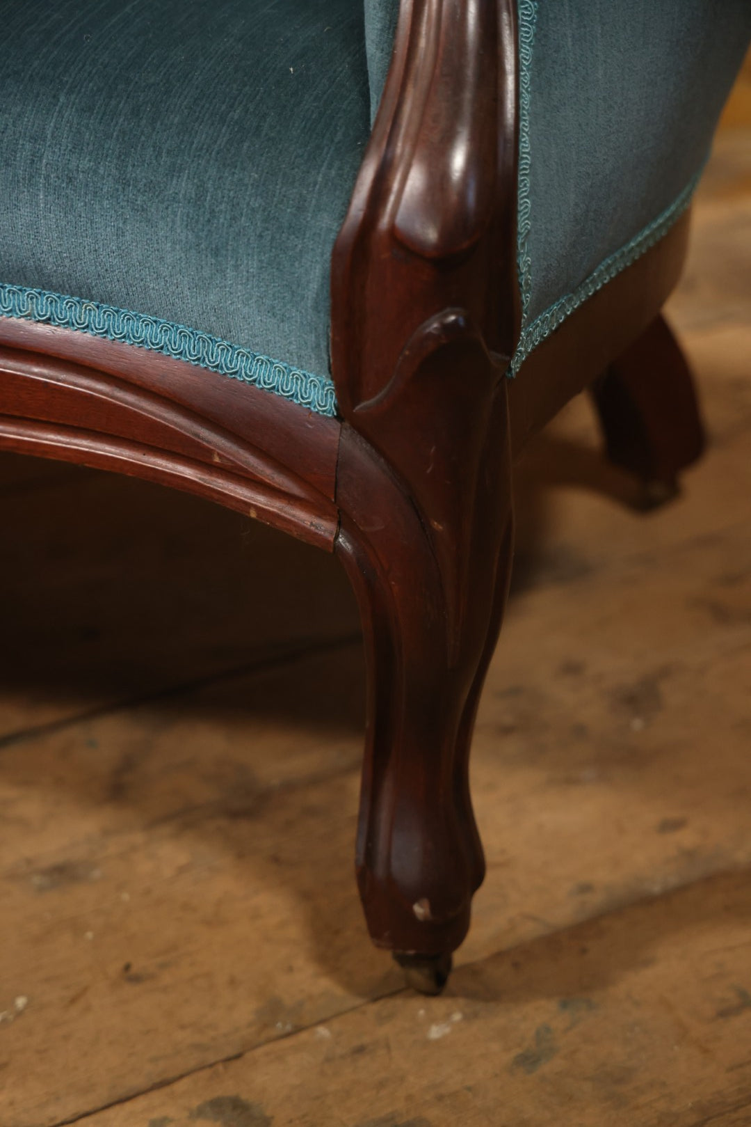Antique Victorian Carved Walnut Settee With Tufted Blue Upholstery And Casters
