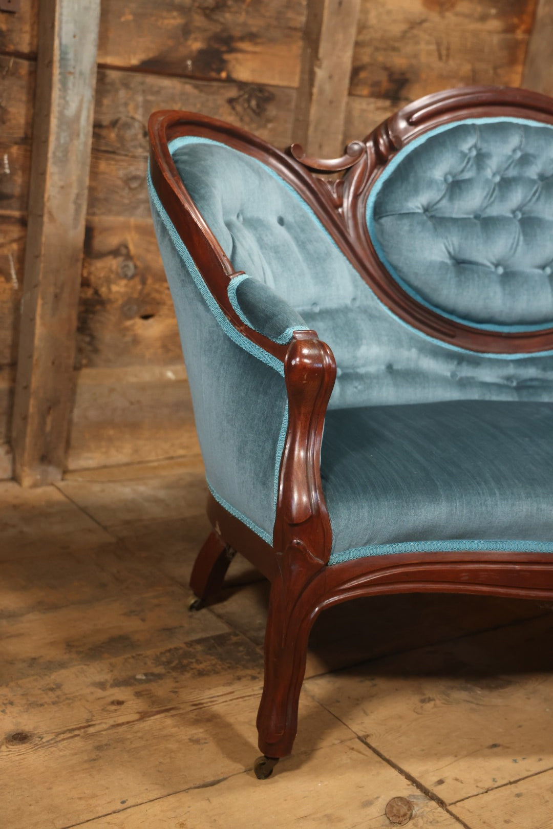 Antique Victorian Carved Walnut Settee With Tufted Blue Upholstery And Casters