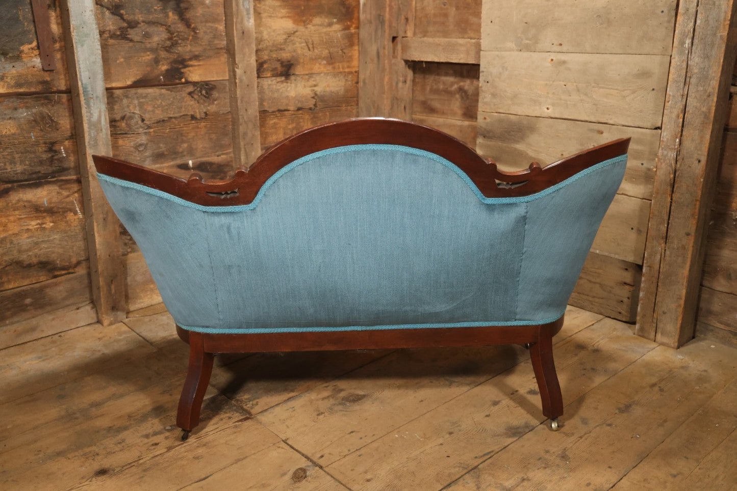 Antique Victorian Carved Walnut Settee With Tufted Blue Upholstery And Casters